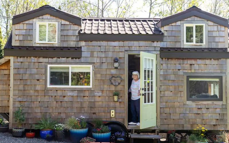 Person Holding the Door Open in a Tiny Home